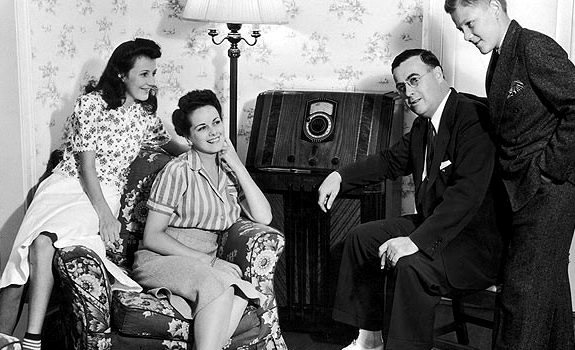 Vintage photo showing a family listening to the radio