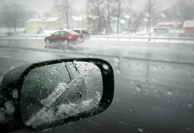 Photo of winter road, looking through a car windshield.