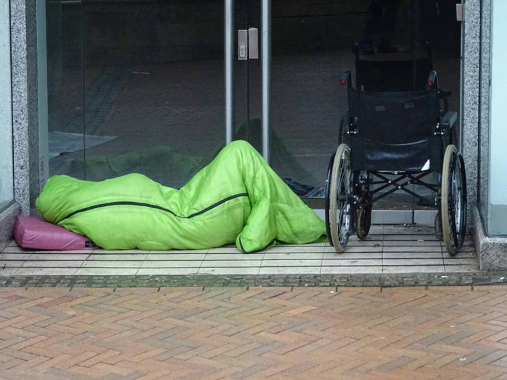 Photo of homeless person sleeping in a doorway